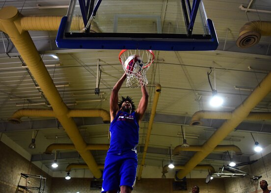 Harlem Globetrotter “Hammer” Harrison dunks during a visit to the 386th Air Expeditionary Wing at an undisclosed location in Southwest Asia, Nov. 30, 2015. The Harlem Globetrotters are an exhibition basketball team and one of the most recognizable franchises in the sport. (U.S. Air Force photo by Staff Sgt. Jerilyn Quintanilla)