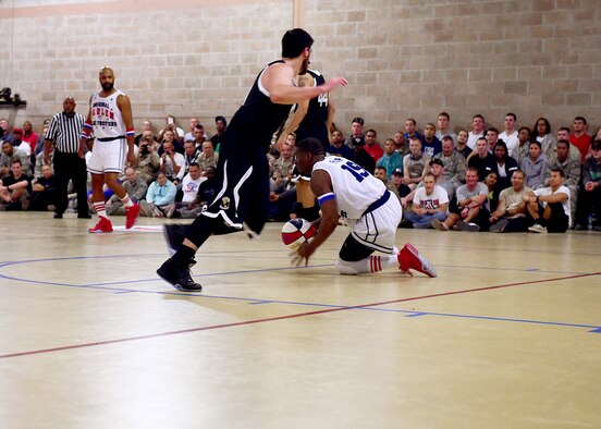 Harlem Globetrotter “Flip” White demonstrates his dribbling skills during a game against the World All Stars at an undisclosed location in Southwest Asia, Nov. 30, 2015. One of the most recognizable franchises in basketball, the Harlem Globetrotter’s performance combines athleticism, comedic tricks and stunts. (U.S. Air Force photo by Staff Sgt. Jerilyn Quintanilla) 