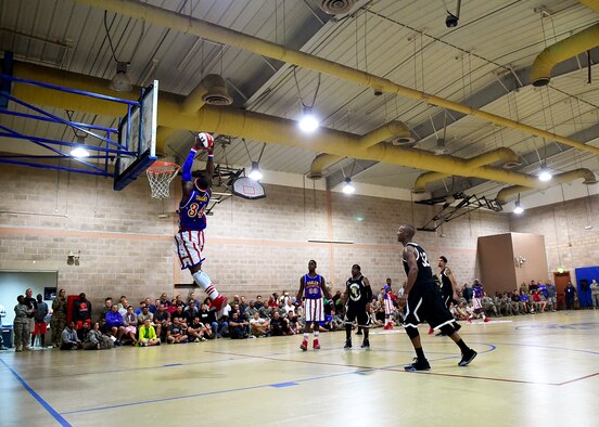 Harlem Globetrotter “Thunder” Law takes the ball to the rim during a game at an undisclosed location in Southwest Asia, Nov. 30, 2015. The Harlem Globetrotters paid a special visit to the service members currently deployed to Southwest Asia in support of Operation INHERENT RESOLVE. (U.S. Air Force photo by Staff Sgt. Jerilyn Quintanilla)