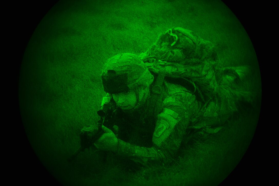 As seen through a night-vision device, a U.S. soldier provides security after participating in an airborne operation onto Juliet drop zone in Pordenone, Italy, Dec. 1, 2015. The soldier is a paratrooper assigned to 1st Battalion, 503rd Infantry Regiment, 173rd Airborne Brigade. U.S. Army photo by Paolo Bovo