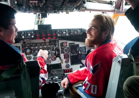 Michael Latta, Washington Capitals center forward (left), and Braden Holtby, Capitals goalie (right), share a laugh inside the cockpit of a 459th Air Refueling Wing KC-135R Stratotanker during a team tour at Joint Base Andrews, Md., Dec. 1, 2015. The Capitals observed special performances by the U.S. Air Force band Max Impact, Honor Guard, 11th Wing Explosive Ordnance Disposal, as well as static displays from the 1st Helicopter Squadron and 113th Wing, Air National Guard. (U.S. Air Force photo by Staff. Sgt. Kat Justen)

