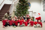 DLA Distribution commander Army Brig. Gen. Richard Dix help the children of the Defense Distribution Center, Susquehanna Child Development Center magically light the tree on Dec. 2.