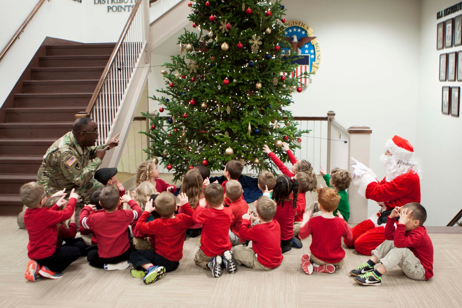 DLA Distribution commander Army Brig. Gen. Richard Dix help the children of the Defense Distribution Center, Susquehanna Child Development Center magically light the tree on Dec. 2.