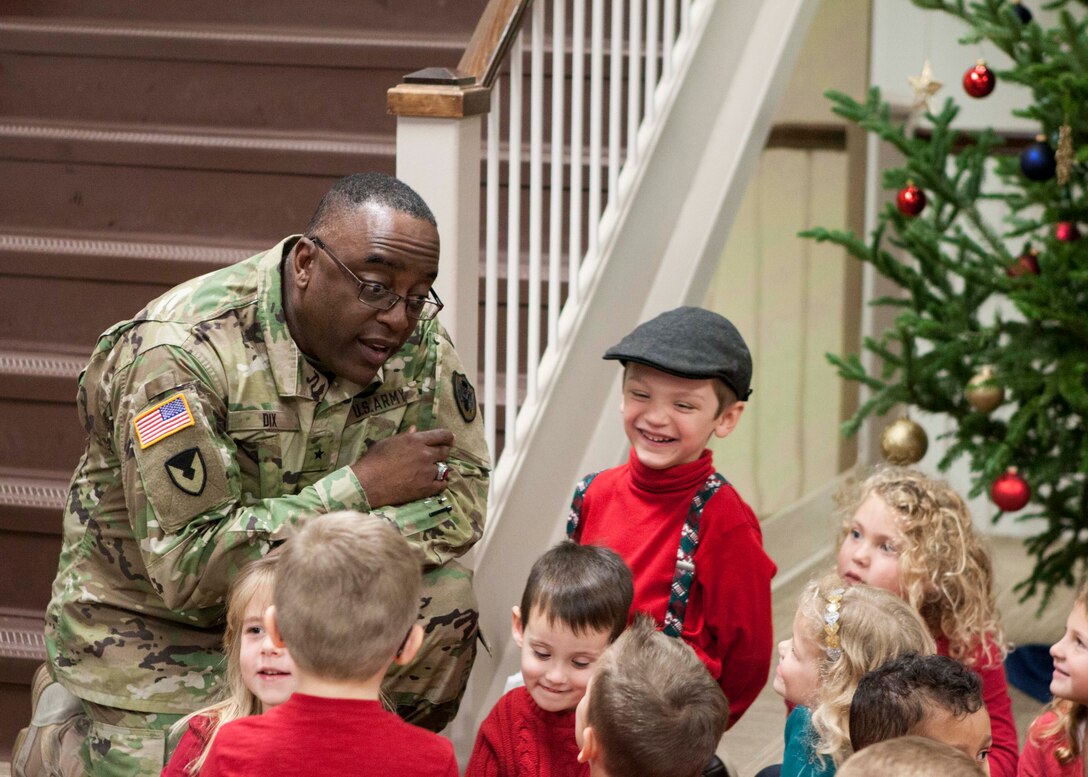DLA Distribution commander Army Brig. Gen. Richard Dix asks the children what they are hoping for this holiday season.