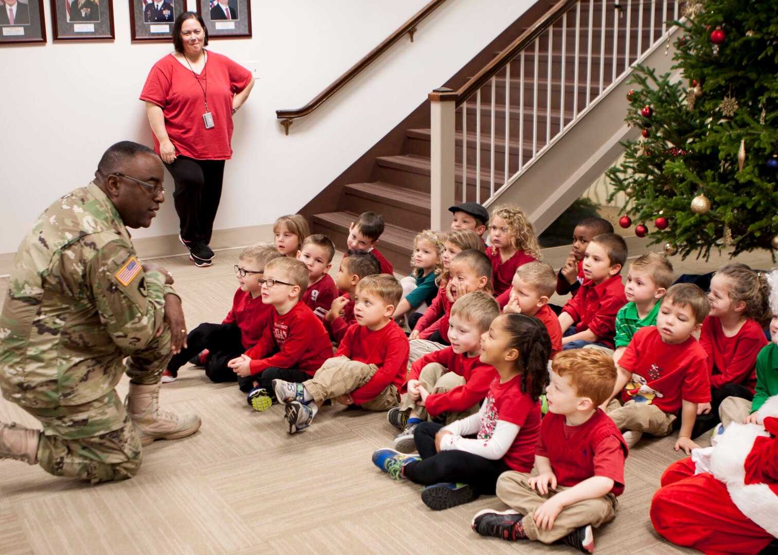DLA Distribution commander Army Brig. Gen. Richard Dix asks the children of the Defense Distribution Center, Susquehanna Child Development Center about their plans for the holiday season.