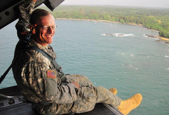 Richard Dabal, a physical scientist, in a Chinook helicopter off the coast of Liberia (West Africa) on New Year's Eve 2014. He was heading home after a 3-month deployment to Liberia fighting the Ebola virus.