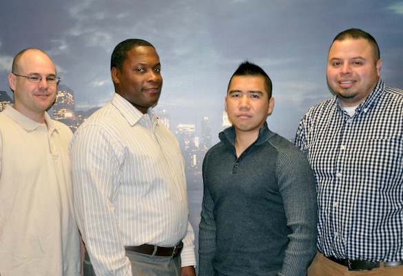 Logistics Management personnel take time out for a photo. From left to right: James Gains, Allen Crenshaw, Fen Chen, and Andres Garcia. Logistics Management oversees the New York District's fleet of vehicles; building maintenance and renovations; investigates property loss; and now implementing Presidential Executive Order 13963 by creating a Vehicle Utilization Review Board (VURB) to reduce fuel consumption.   