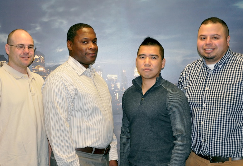 Logistics Management personnel take time out for a photo. From left to right: James Gains, Allen Crenshaw, Fen Chen, and Andres Garcia. Logistics Management oversees the New York District's fleet of vehicles; building maintenance and renovations; investigates property loss; and now implementing Presidential Executive Order 13963 by creating a Vehicle Utilization Review Board (VURB) to reduce fuel consumption.   