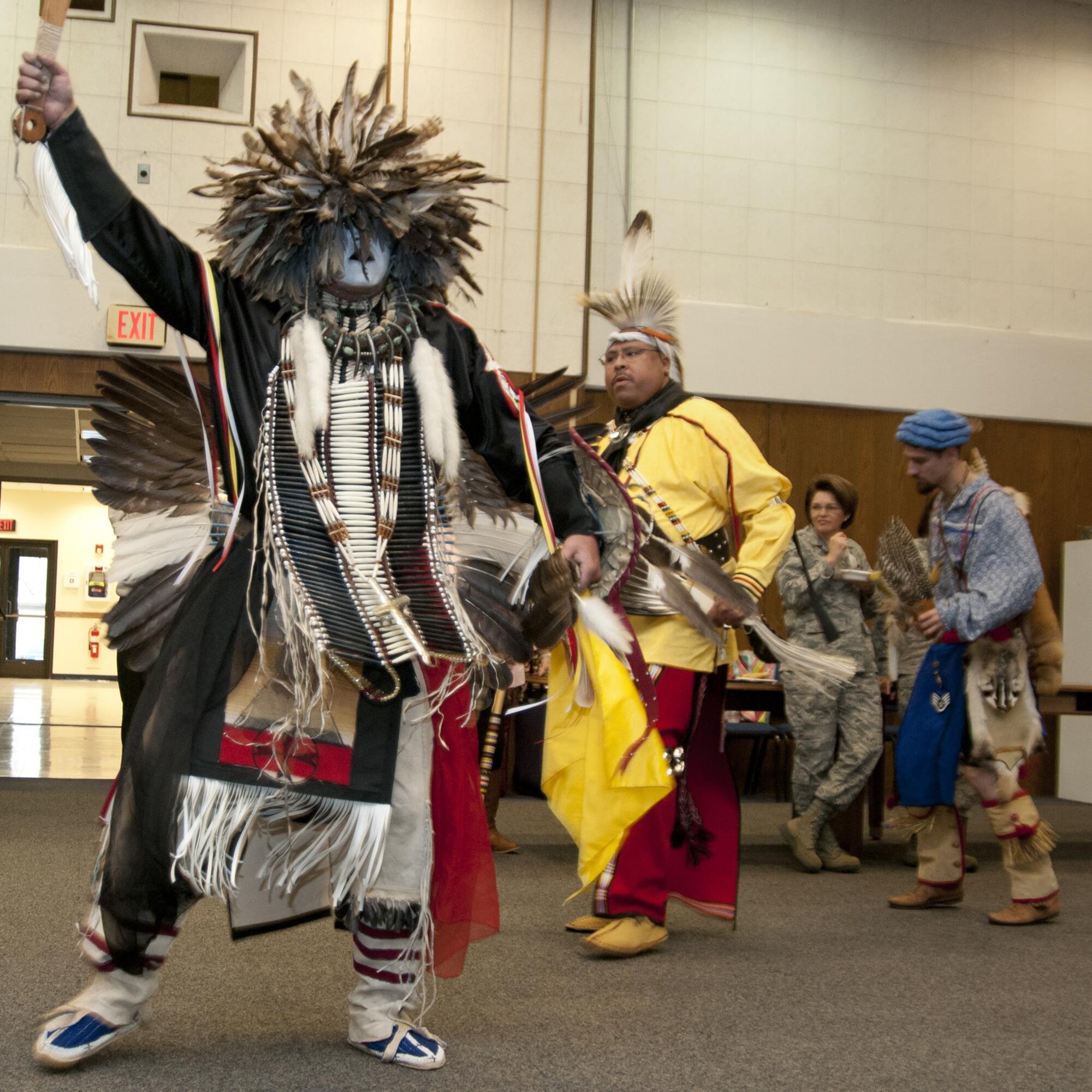 Charles Eagle Tail of the Mi-Kamaq tribe performs a ceremonial dance during the Native American Heritage Month celebration at the 459th Air Refueling Wing auditorium Nov. 30, 2015. The dance was one of many performed during the event, which also included northern, southern and friendship. (U.S. Air Force photo by Staff Sgt. Kat Justen) 
