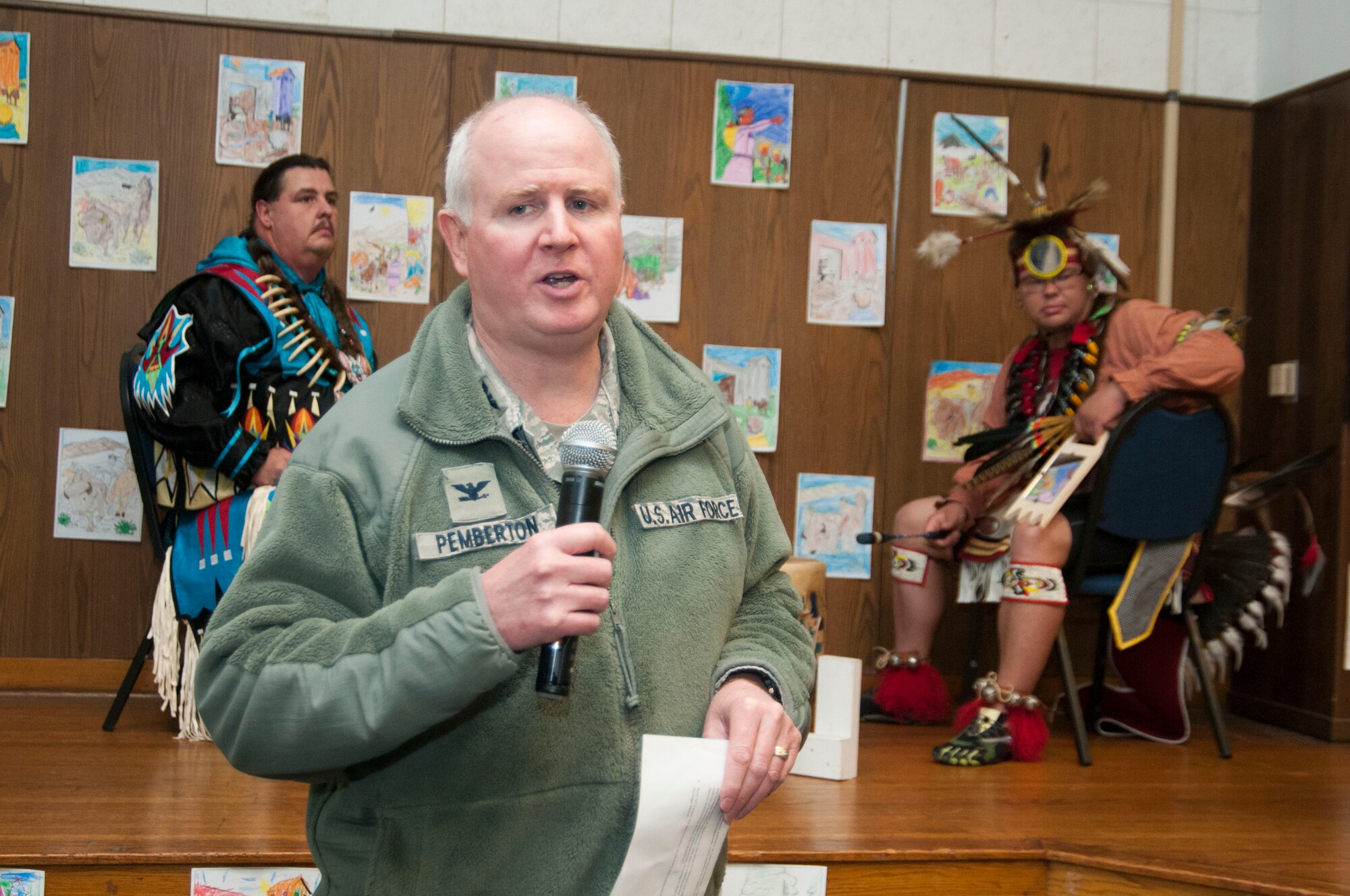 Col. Thomas “Thom” Pemberton, 459th Operations Group commander and host for the Native American Heritage Month culmination celebration, provides opening remarks for the event in the 459th Air Refueling Wing auditorium Nov. 30, 2015. This year’s event included traditional food tasting, books, beadwork, weaponry, music and dancing from half a dozen Native American tribes. (U.S. Air Force photo by Staff Sgt. Kat Justen) 
