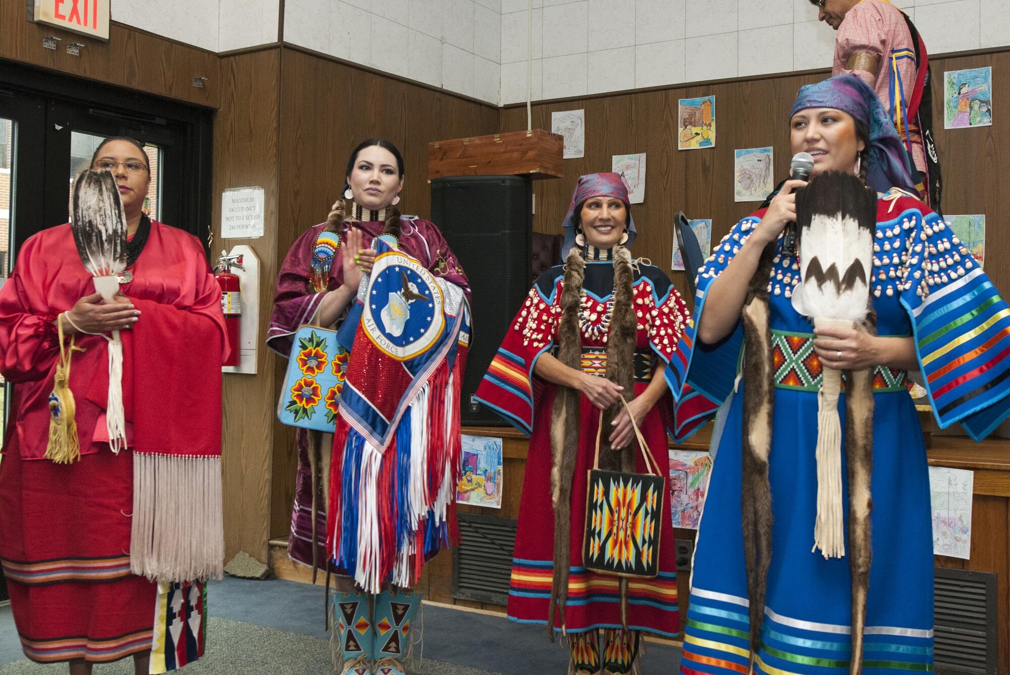 Staff Sgt. Brittinie Alvarez, 811th Security Forces Squadron team leader, gives remarks during the Native American Heritage Month celebration at the 459th Air Refueling Wing auditorium Nov. 30, 2015. This year’s event included traditional food tasting, books, beadwork, weaponry, music and dancing from various Native American tribes. (U.S. Air Force photo by Staff Sgt. Kat Justen) 
