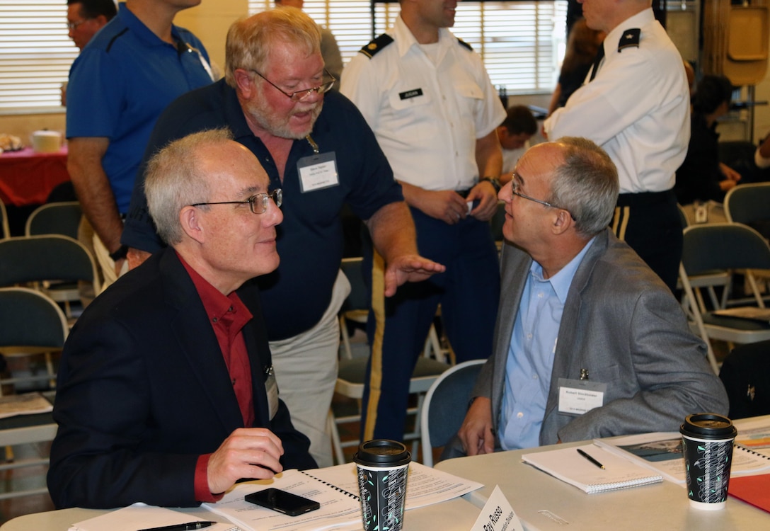 Ray S. Russo, chief, Civil Works and Integration Division, Southwestern Division and Robert Slockbower, Director of Programs, Southwestern Division, interact with one of the many stakeholders in attendance at the McClellan-Kerr Arkansas River Navigation System table top exercise.