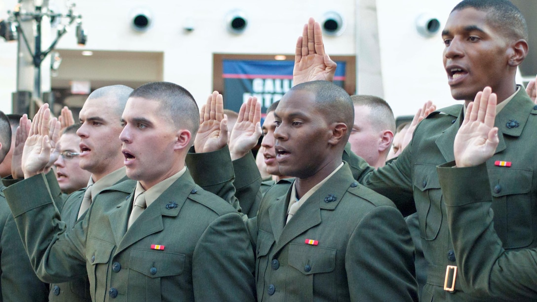 Officer candidates from Class 220 recite the oath for commissioned officers during their commissioning ceremony Nov. 24, 2015 at the National Museum of the Marine Corps in Triangle, Va. These new second lieutenants now head to The Basic School.