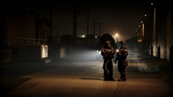 Airmen from the 51st Civil Engineer Squadron explosive ordnance disposal flight discuss the location of simulated unexploded ordnance during a training scenario at Osan Air Base, South Korea, Nov. 6, 2015. EOD training usually consists of deployed IED scenarios, mine detection and electronic countermeasures to ensure their fight tonight readiness. (U.S. Air Force photo/Tech. Sgt. Travis Edwards)