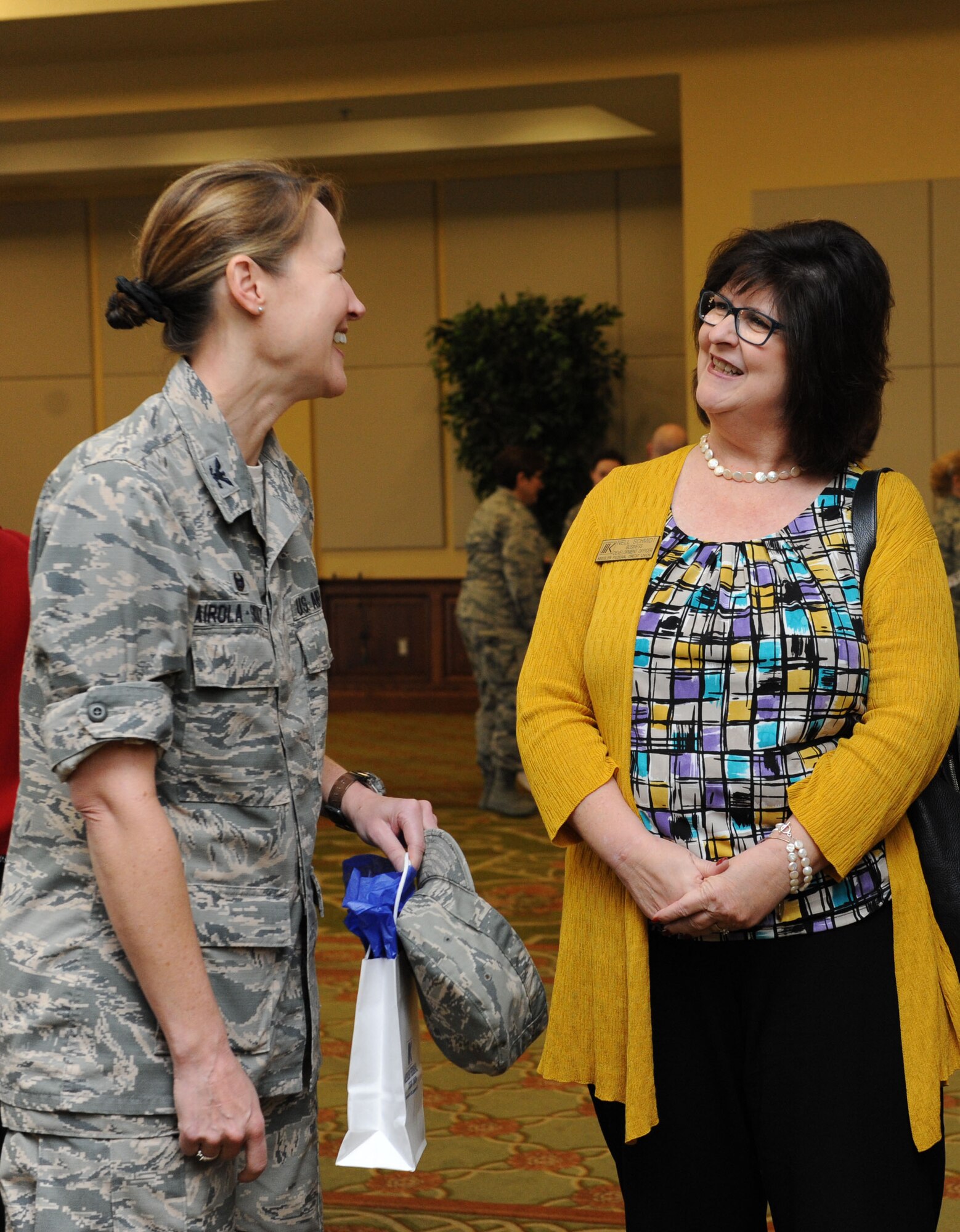 Col. Susan Airola-Skully, 81st Mission Support Group commander, and Nell Schmidt, Keesler Federal Credit Union development officer, share a laugh during the Biloxi Chamber of Commerce Morning Call at the Bay Breeze Event Center Dec. 1, 2015, Keesler Air Force Base, Miss. Keesler hosted the event. (U.S. Air Force photo by Kemberly Groue)