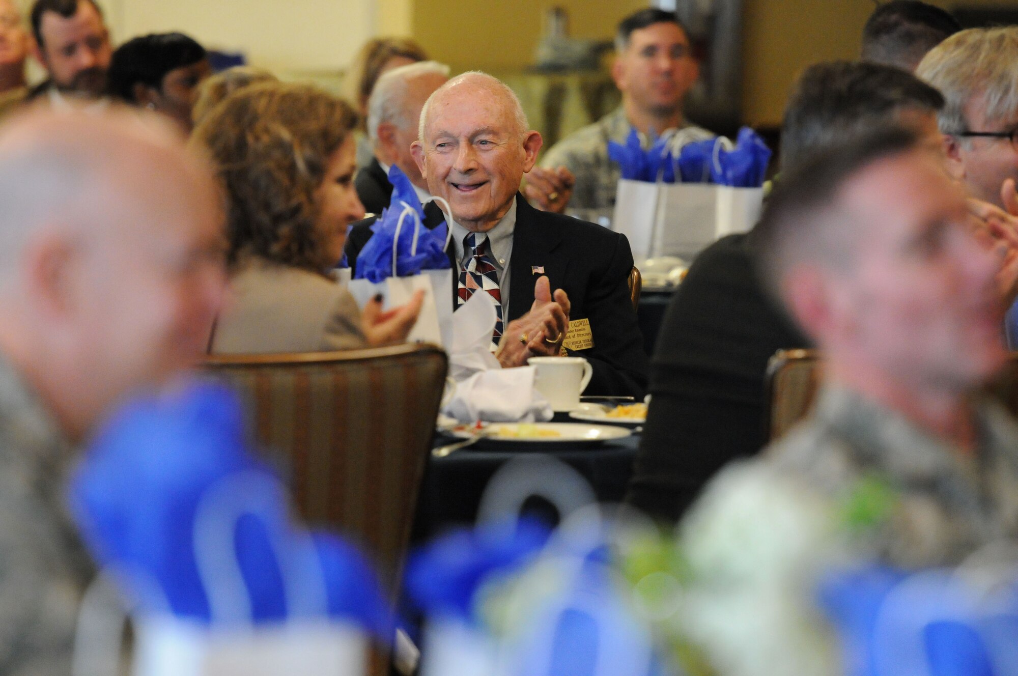Jerry Caldwell, Keesler Federal Credit Union board of directors, sits among Keesler personnel and local community members, listening to keynote speakers during the Biloxi Chamber of Commerce Morning Call at the Bay Breeze Event Center Dec. 1, 2015, Keesler Air Force Base, Miss. Keesler hosted the event. (U.S. Air Force photo by Kemberly Groue)