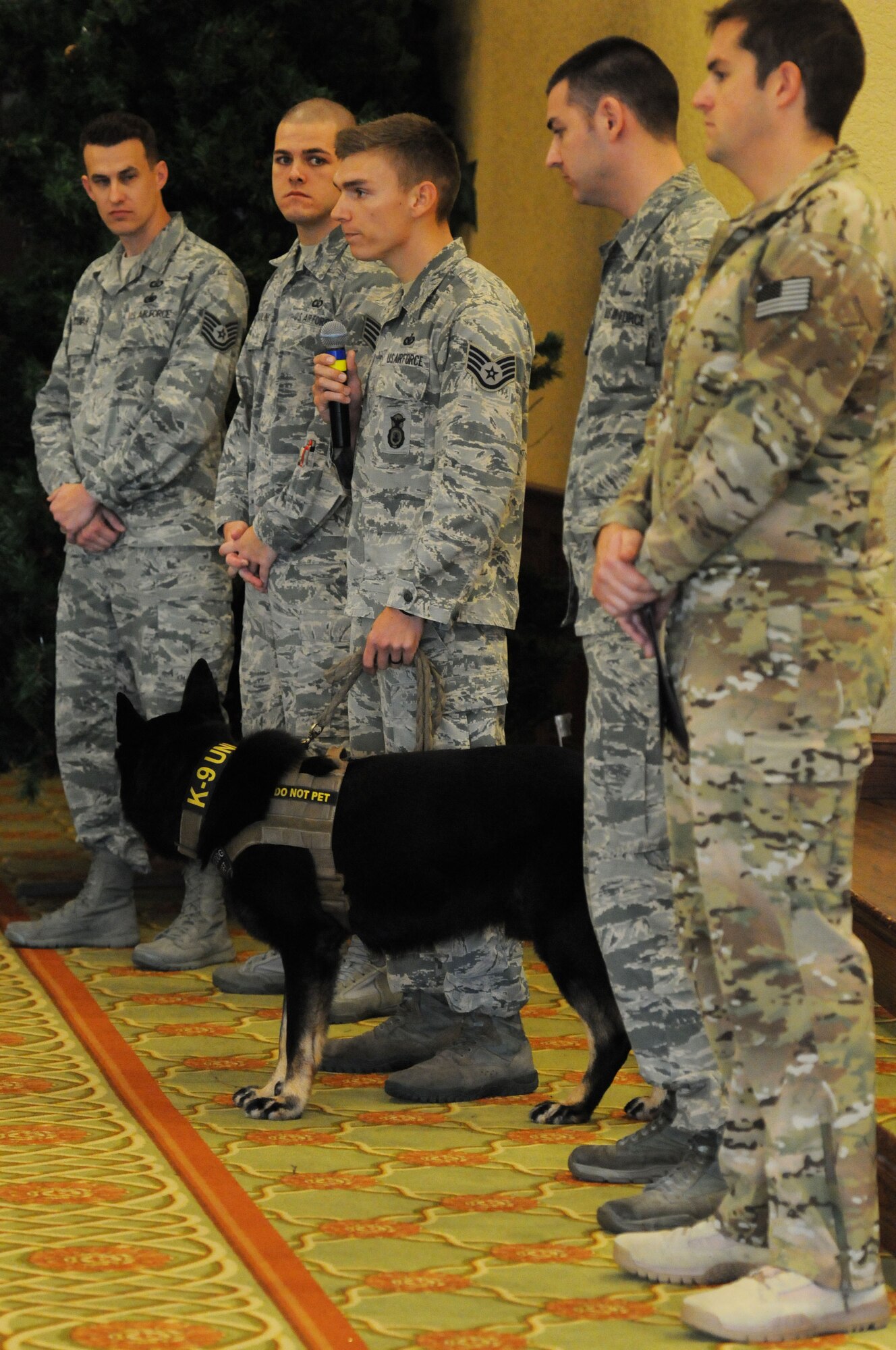 Staff Sgt. Jordan Leiter, 81st Security Forces Squadron military working dog handler, briefs on his duties as a handler during the Biloxi Chamber of Commerce Morning Call at the Bay Breeze Event Center Dec. 1, 2015, Keesler Air Force Base, Miss. Keesler hosted the event. (U.S. Air Force photo by Kemberly Groue)