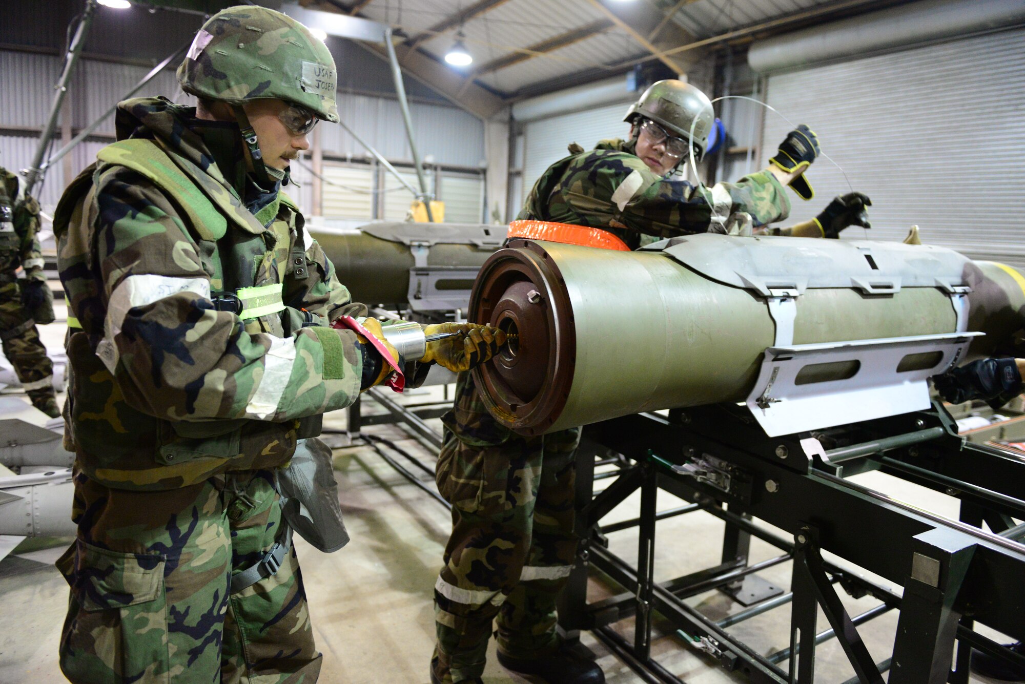 Airmen from the 51st Munitions Squadron assemble various bomb components during exercise Vigilant Ace 16 at Osan Air Base, Republic of Korea, Nov. 6, 2015. The sensitivity of the devices to radio signals and electricity is something that must be kept in mind during each construction and requires the establishment of maximum safe distance evacuation points.  (U.S. Air Force photo by Staff Sgt. Amber Grimm/Released)