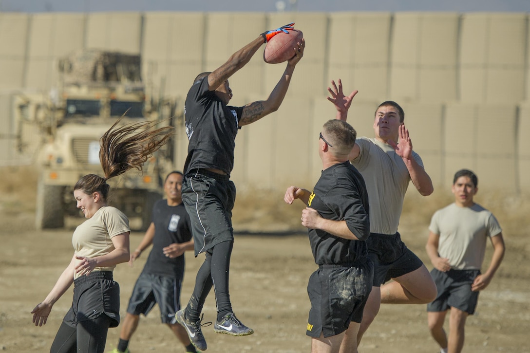 Members of Florida Army National Guard’s 1st Battalion, 265th Air Defense Artillery Regiment play members from Florida Air National Guard’s 290th Joint Communications Support Squadron in a friendly "Turkey Bowl" football game at Bagram Airfield, Afghanistan, Nov. 26, 2015. The Army National Guard team won the game 42-35. The 1-265th is from Palm Coast, Fla., and the 290th JCSS are stationed at MacDill Air Force Base, Fla.