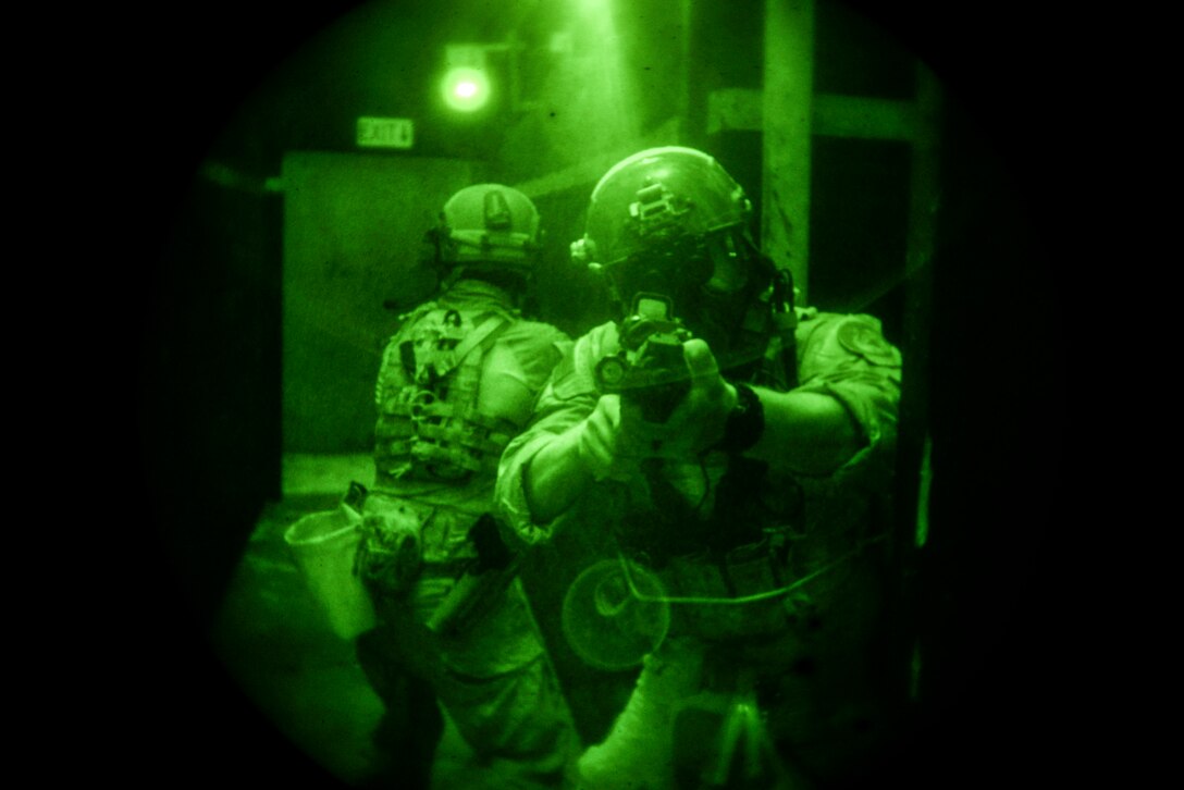 Airmen from the 320th Special Tactics Squadron clear a hallway Nov. 19, 2015, in a shoot house at Camp Hansen, Japan. The Airmen cleared the house as part of training led by the Direct Action Resource Center during a two-week course where a group of pararescuemen, combat controllers and force reconnaissance Marines develop skills they can use when they deploy with other joint special operations teams. (U.S. Air Force photo/Senior Airman John Linzmeier)