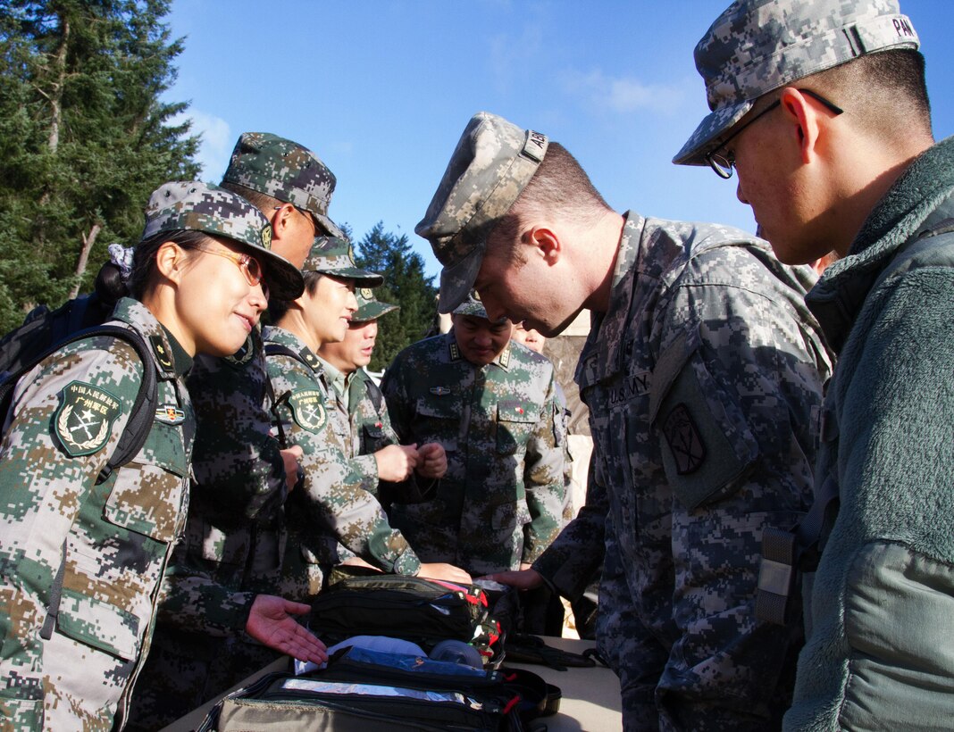 U. S. soldiers are shown a variety of medical bags used by Chinese soldiers during a disaster management exchange at Joint Base Lewis-McChord, Wash., Nov. 20, 2015. The training was an opportunity to share lessons learned from real-world humanitarian aid and disaster relief events and aimed to improve U. S. and Chinese dialog for future events. U. S. Army photo by Staff Sgt. Trish McMurphy