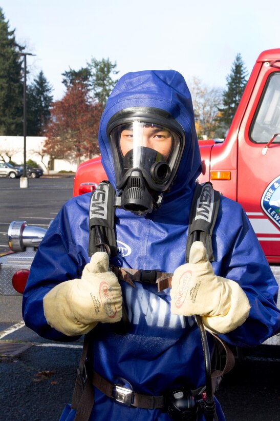 A Chinese soldier gives the "thumbs up" after donning decontamination protective gear during a disaster management exchange at Joint Base Lewis-McChord, Wash., Nov. 20, 2015. U. S. Army photo by Staff Sgt. Trish McMurphy