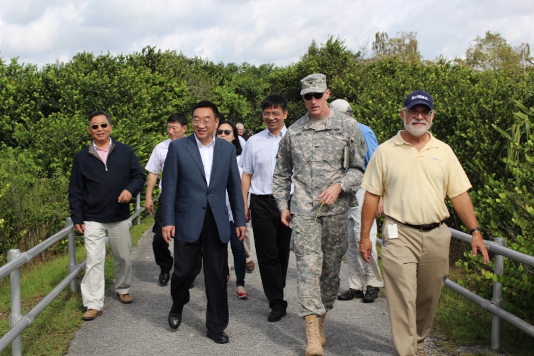Thomas Teets, Director of the Office of Everglades Policy and Coordination of the South Florida Water Management District, Jacksonville District Commander Col. Jason Kirk, Water Resources Minister Chen Lei (front, right to left) and members of the Chinese delegation head to the observation tower during a tour of Shark Valley in Everglades National Park.