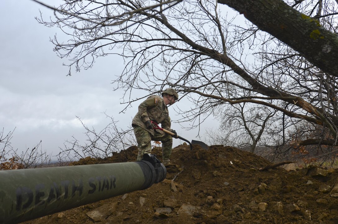 U.S. Army Pfc. Clayton Sharp levels of the top of a mound in front of the hull-down battle position for an M1A2 Abrams Tank during Exercise Peace Sentinel at Novo Selo Training Center, Bulgaria, Nov. 23, 2015. Sharp is a combat engineer assigned to the 3rd Infantry Division’s 5th Squadron, 7th Cavalry Regiment. U.S. Army photo by Staff Sgt. Steven M. Colvin