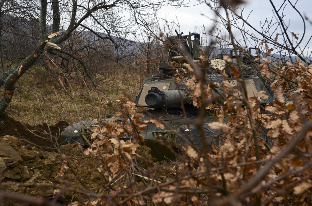 U.S. soldiers man an M1A2 Abrams tank concealed by a hull-down battle position during Exercise Peace Sentinel at Novo Selo Training Center, Bulgaria, Nov. 23, 2015. U.S. Army photo by Staff Sgt. Steven M. Colvin