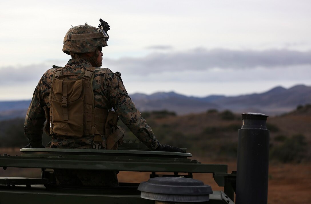 Corporal Christan Curz observes a High-Mobility Artillery Rocket System fire in support of Steel Knight aboard Marine Corps Base Camp Pendleton, Calif., Dec. 4, 2015. Steel Knight is a 1st Marine Division led exercise which enables the Marines and sailors to operate in a realistic combined-arms environment to develop skill sets necessary to operate as a fully capable Marine Air Ground Task Force. Curz is an artilleryman assigned to Battery Q, 5th Battalion, 11th Marine Regiment, 1st Marine Division.