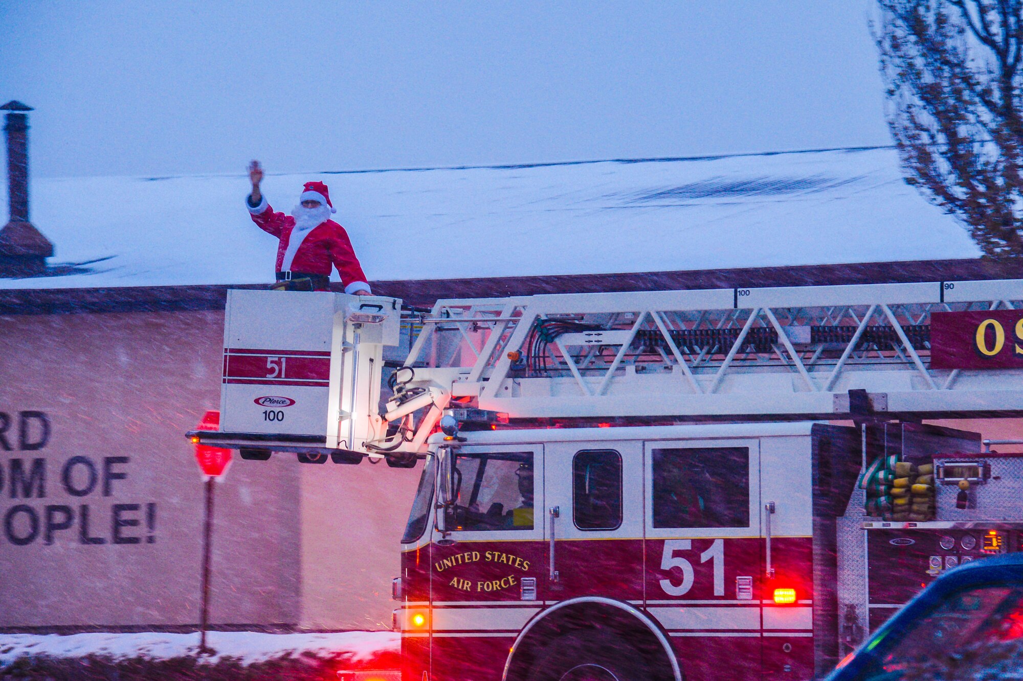 A 51st Civil Engineer Squadron fire truck ferries Santa Claus to the annual Holiday Tree Lighting ceremony at Osan Air Base, Republic of Korea, Dec. 3, 2015. Children of Team Osan visited with Santa and shared their holiday wishes following the ceremony. (U.S. Air Force photo/Airman 1st Class Dillian Bamman)