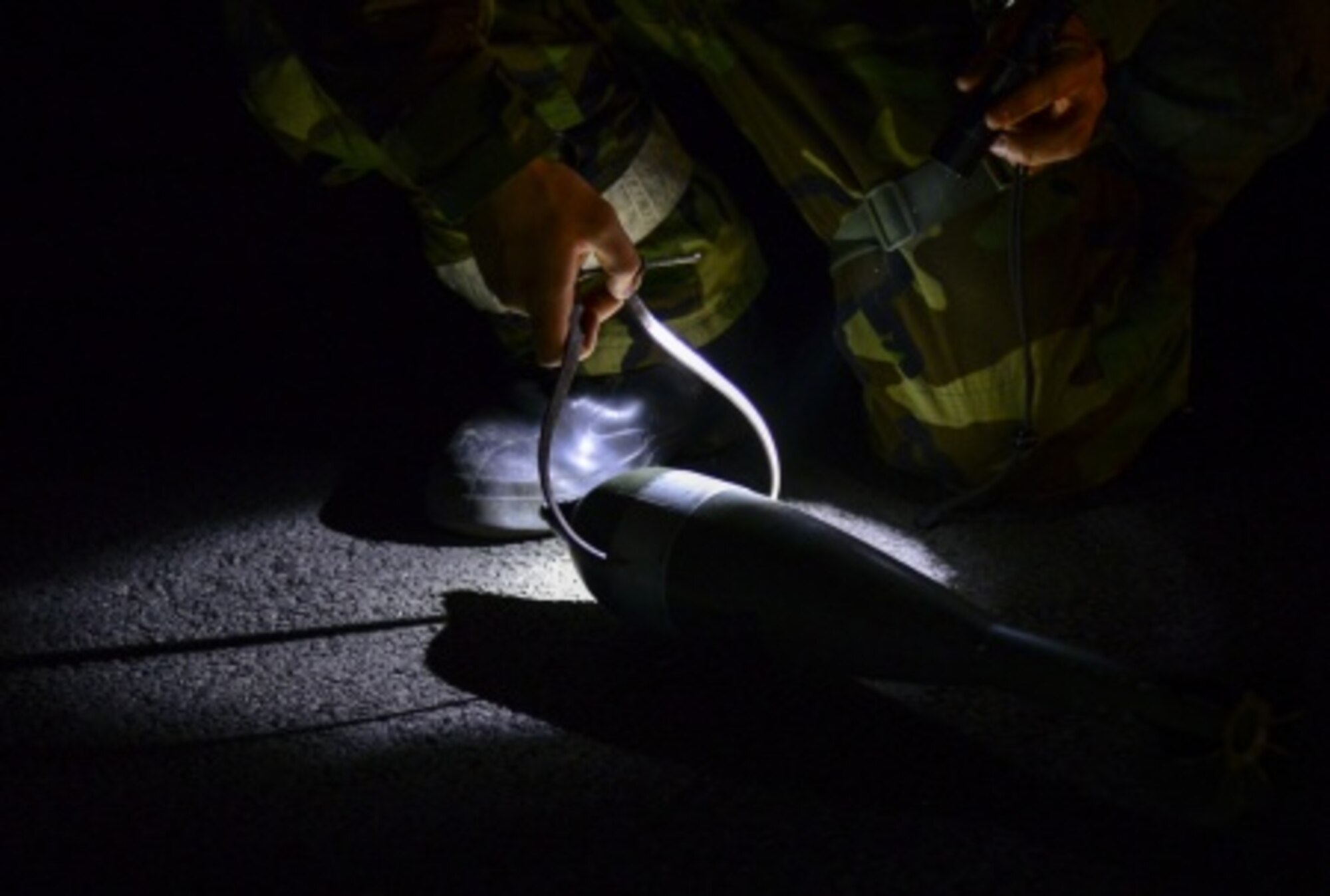 A 51st Civil Engineer Squadron explosive ordnance disposal technician measures the diameter of a simulated unexploded mortar round during a training scenario at Osan Air Base, Republic of Korea, Nov. 6, 2015. After finding unexploded ordnance, EOD stores them to perform controlled detonations in a secured area. (U.S. Air Force photo/Tech. Sgt. Travis Edwards)
