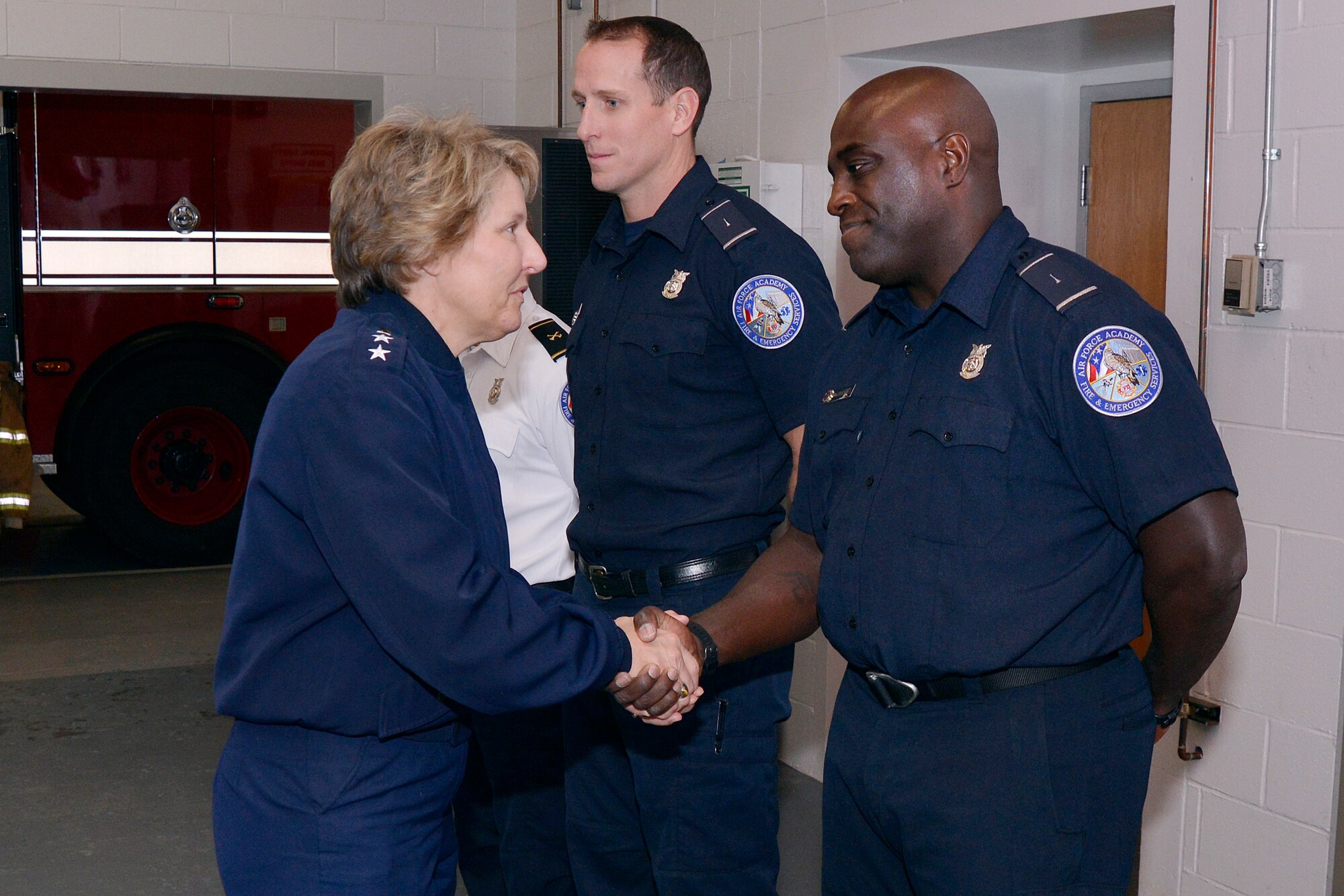 Anthony McMurtry, a Defense Department firefighter, shakes hands with Lt. Gen. Michelle Johnson, the superintendent of the Air Force Academy, Nov. 30, 2015. McMurtry was among the 10th Civil Engineer Squadron Emergency Services Flight firefighters recognized by the general for their efforts during a national firefighting competition Nov. 30. (U.S. Air Force photo/Jason Gutierrez)