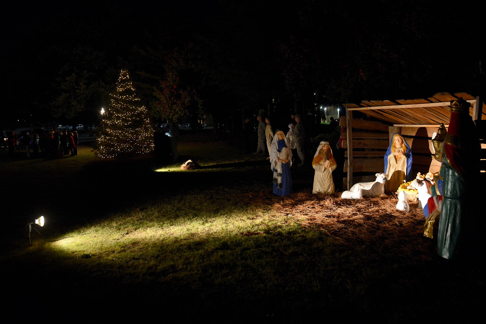 Team Shaw members and their families observe a Christmas Tree Lighting/Religious Display Interfaith Ceremony at the Friendship Chapel, Dec. 3, 2015, at Shaw Air Force Base, S.C. Hosted by the 20th Fighter Wing Chaplain Corps, four holiday displays were lit; a Yule log, Menorah, Nativity Scene, and Christmas Tree. (U.S. Air Force photo by Airman 1st Class Christopher Maldonado)