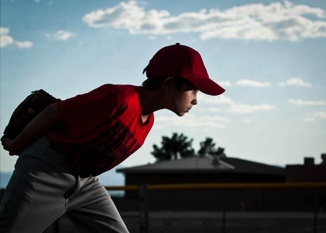 Seth, 8, leans in before throwing a pitch at Nellis Air Force Base, Nev., May 3, 2015. Seth plays in the Nellis Youth Center's youth baseball league, which is only open to U.S. military dependents. (U.S. Air Force photo by Staff Sgt. Siuta B. Ika)