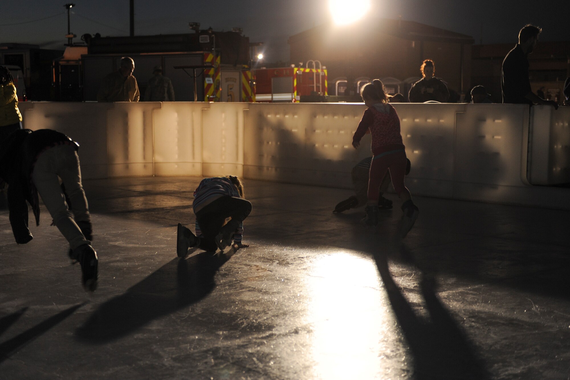 Children skate around an ice rink during the Starry, Snowy, Southwest Night event at Davis-Monthan Air Force Base, Ariz., Dec. 3, 2013. In addition to the ice rink, sixty tons of snow were split into two areas for people of all ages to play. (U.S. Air Force photo by Airman Basic Nathan H. Barbour/Released)