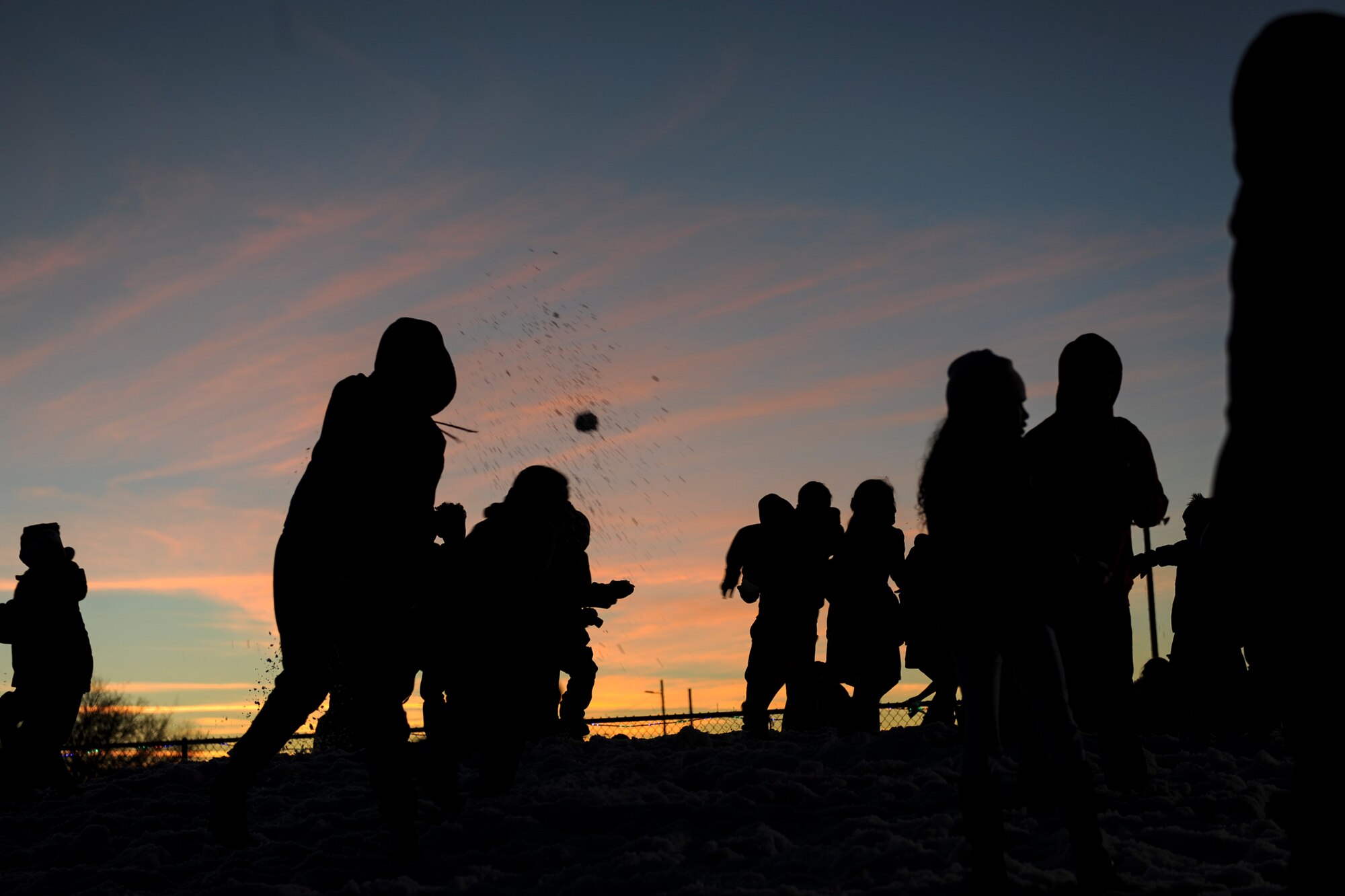 Children play in the snow during the Starry, Snowy, Southwest Night event at Davis-Monthan Air Force Base, Ariz., Dec. 3, 2015. Sixty tons of snow were made for the event and divided into two areas for different age groups. (U.S. Air Force photo by Airman Basic Nathan H. Barbour/Released)