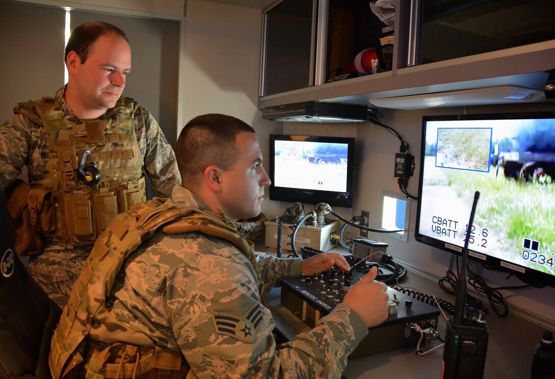 Staff Sgt. Jeffrey Butera and Senior Airman Randall Brown, explosive ordnance disposal technicians from the 932nd Civil Engineer Squadron, conduct a bomb disposal robot operation during a WMD and IED training scenario that took place July 12 at Scott Air Force Base, Illinois. (U.S. Air Force photo by Tech. Sgt. Jodi Ames)