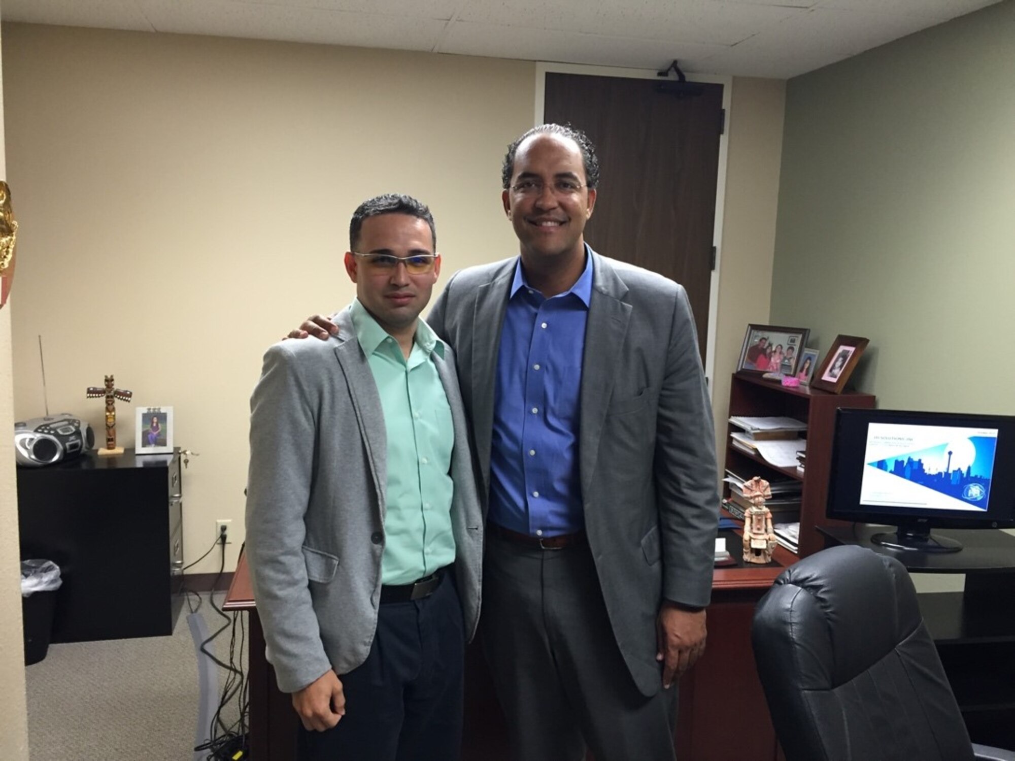 U.S. Air Force Reserve Senior Airman Cesar Zayas (standing, left) poses for a photo with Congressman William Hurd, the U.S. Representative for Texas' 23rd congressional district, at ITI Solutions Inc.'s Corporate Office in San Antonio, Texas. Zayas transitioned from the active component of the U.S. Army and began working for the cyber-security contracting firm, which has afforded him the opportunity to engage with military and civic leaders in both the United States and Mexico. (Courtesy photo)   
