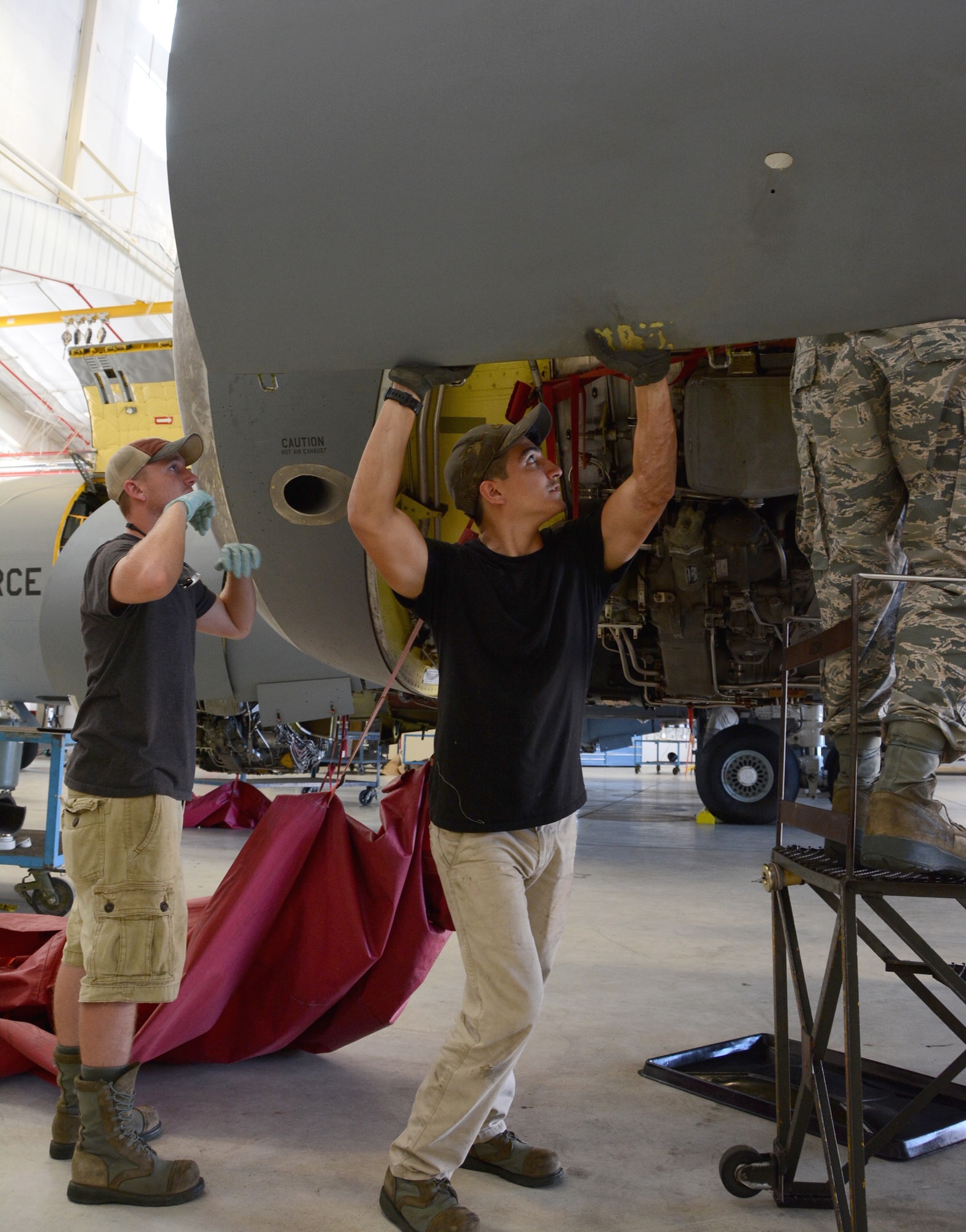 Senior Airman Josh Hines and Senior Airman Adrian Condit, crew chiefs from
the 507th Aircraft Maintenance Squadron, close an outboard engine cowling on a
KC-135 Stratotanker at the end of a -7 inspection Sept. 3, 2015, at Tinker Air Force
Base, Okla. All U.S. Air Force KC-135 Stratotankers require an inspection every
900 flight-hours. (U.S. Air Force photo/Tech. Sgt. Lauren Gleason)


