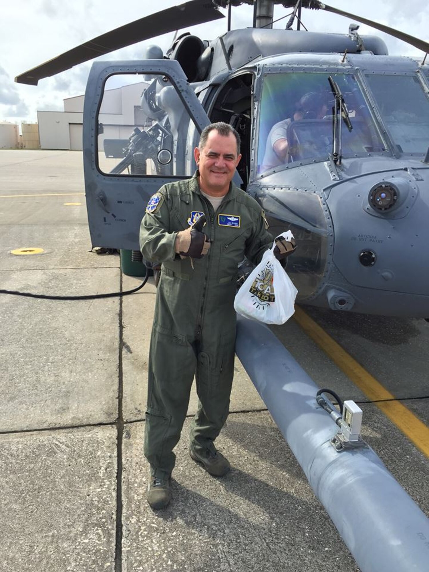 PATRICK AIR FORCE BASE, Fla. - Chief Master Sgt. Lazaro Ibarra, 301st Rescue Squadron special mission aviator here, gives a thumbs up and as he prepares to board an HH-60G Pave Hawk helicopter with his last official box lunch.  Ibarra’s fini-flight here, Dec. 2 marks end of the chief’s 35-year career.  (Courtesy photo)
