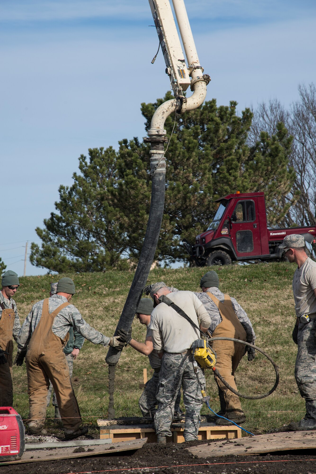 Airmen from the Civil Engineering Squadron poor concrete for the new pavilion by the James Gym track November 24, 2015 at Scott Air Force base Illinois. The pavilion will be 50x100 feet and comfortably fit a unit of 50 to 60 people. (U.S. Air Force photo by Airman Gwendalyn Smith)