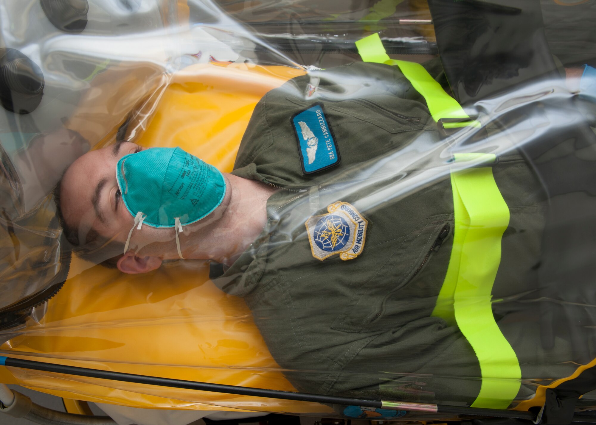 Senior Airman Peter Cannizzaro, 9th Airlift Squadron loadmaster, lays inside a single patient bio-containment unit (isolation pod) Nov. 3, 2015, in the 436th Medical Group on Dover Air Force Base, Del. This isolation pod is currently the only one in Delaware. (U.S. Air Force photo/Senior Airman Zachary Cacicia)