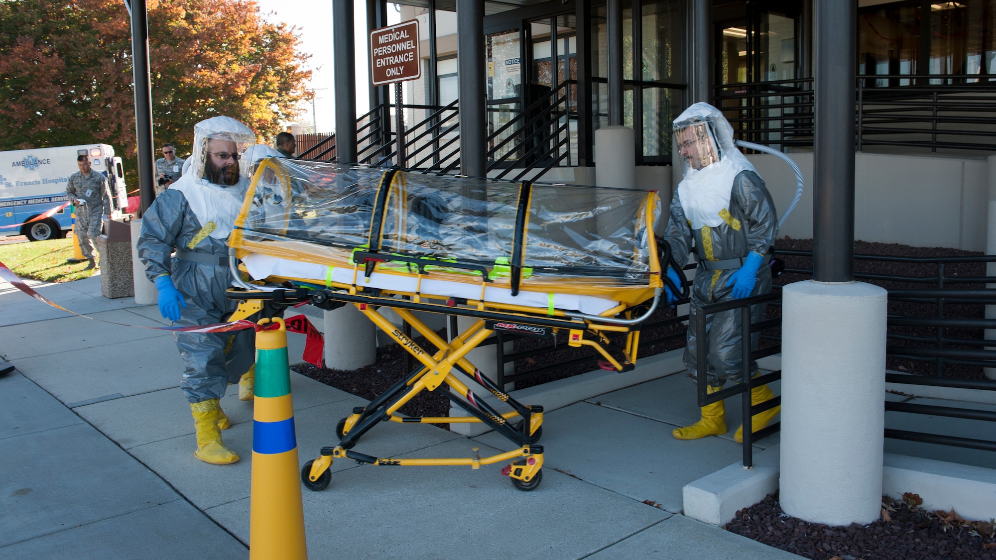 Brett Zingarelli and Dave Brown, St. Francis Healthcare emergency medical technicians, move a single patient bio-containment unit (isolation pod) into the 436th Medical Group Clinic during an Ebola Response Plan and Transport exercise Nov. 3, 2015, at Dover Air Force Base, Del. This isolation pod is normally on standby at a St. Francis medical center in Wilmington, Del. (U.S. Air Force photo/Senior Airman Zachary Cacicia)