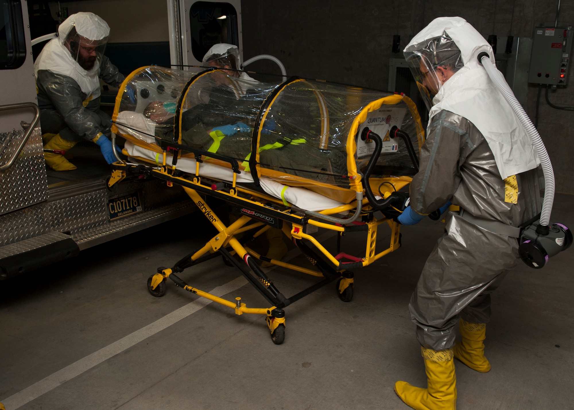 Brett Zingarelli, Brittany Farra and Dave Brown, St. Francis Healthcare emergency medical technicians, move a single patient bio-containment unit (isolation pod) carrying Senior Airman Peter Cannizzaro, 9th Airlift Squadron loadmaster, out of an ambulance Nov. 3, 2015, at Wilmington Hospital in Wilmington, Del. Zingarelli, Farra and Brown are part of a special operations team that is designed to safely transport highly infectious patients. (U.S. Air Force photo/Senior Airman Zachary Cacicia)