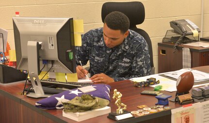 Hospital Corpsman 2nd Class Carson Mayes, Navy Operational Support Center medical representative, reviews a Reservist’s medical status to ensure their mission readiness at the NOSC on Joint Base Charleston – Naval Weapons Station, S.C., Dec. 1, 2015. Mayes is one of two medical department staff members who meet the needs of all 330 of JB Charleston’s Navy Reservists. (U.S. Air Force photo/Airman 1st Class Thomas T. Charlton)