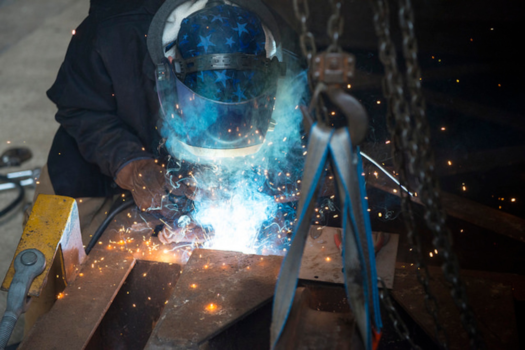Steve Chencharik, 87th Civil Engineer Group high pressure pipe welder, welds a wheel into place on the door of Hangar 5 on Joint Base McGuire-Dix-Lakehurst, N.J. Nov. 30. Hangar 5 was built in the early 1940s and was having issues opening the doors all the way. (U.S. Air Force photo by Senior Airman Joshua King)