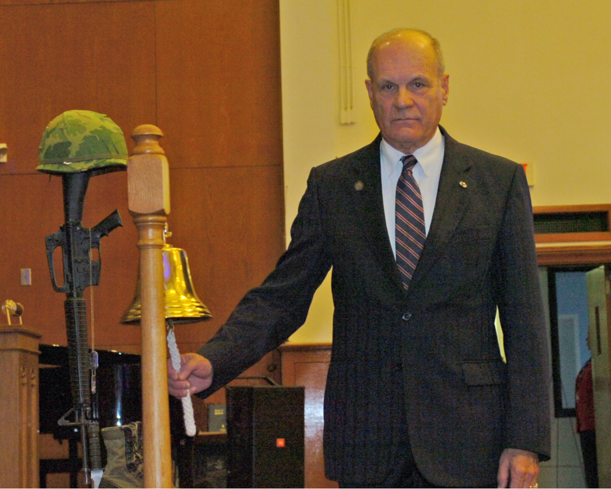 Retired Army Chaplain (Col.) Ronald W. Benzing, tolls the bell, an old Navy tradition, for service members who paid the ultimate price, during the Vietnam War 50th Anniversary Commemoration here Dec. 1. A commemorative 50-year anniversary lapel pin was presented to all veterans who served from November 1965 to April 30, 1975. (U.S. Army photo by David Moore/Released)