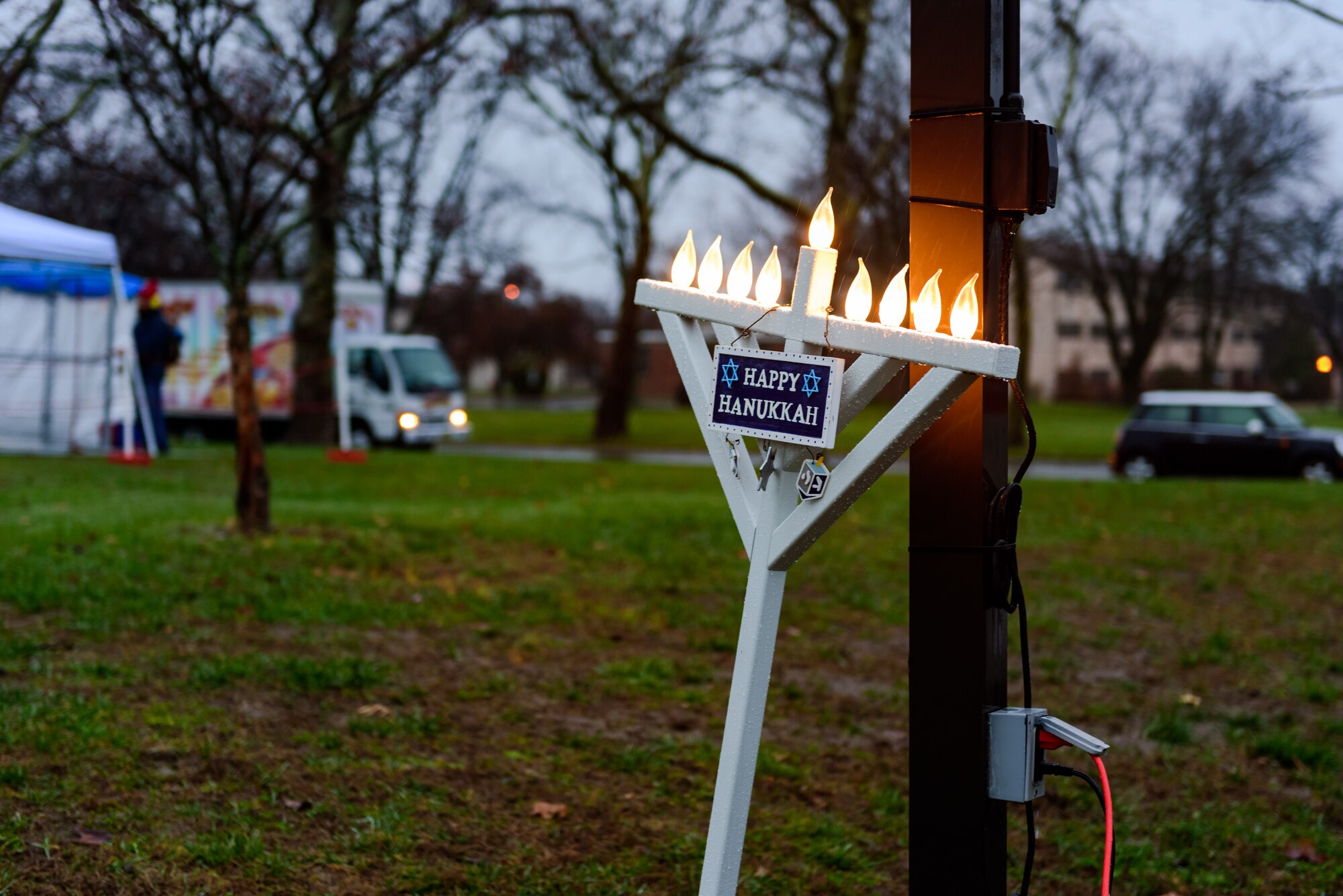 The joint base community gathers for a tree and menorah lighting ceremony outside of Wurman Hall Dec. 2, 2015 at Joint Base McGuire-Dix-Lakehurst, NJ.  Event goers were treated to roasted chestnuts, kettle corn, hot cocoa and hot apple cider; and children had a chance to visit with Santa and Mrs. Claus.  (U.S. Air Force photo by Robert Williard/Released)