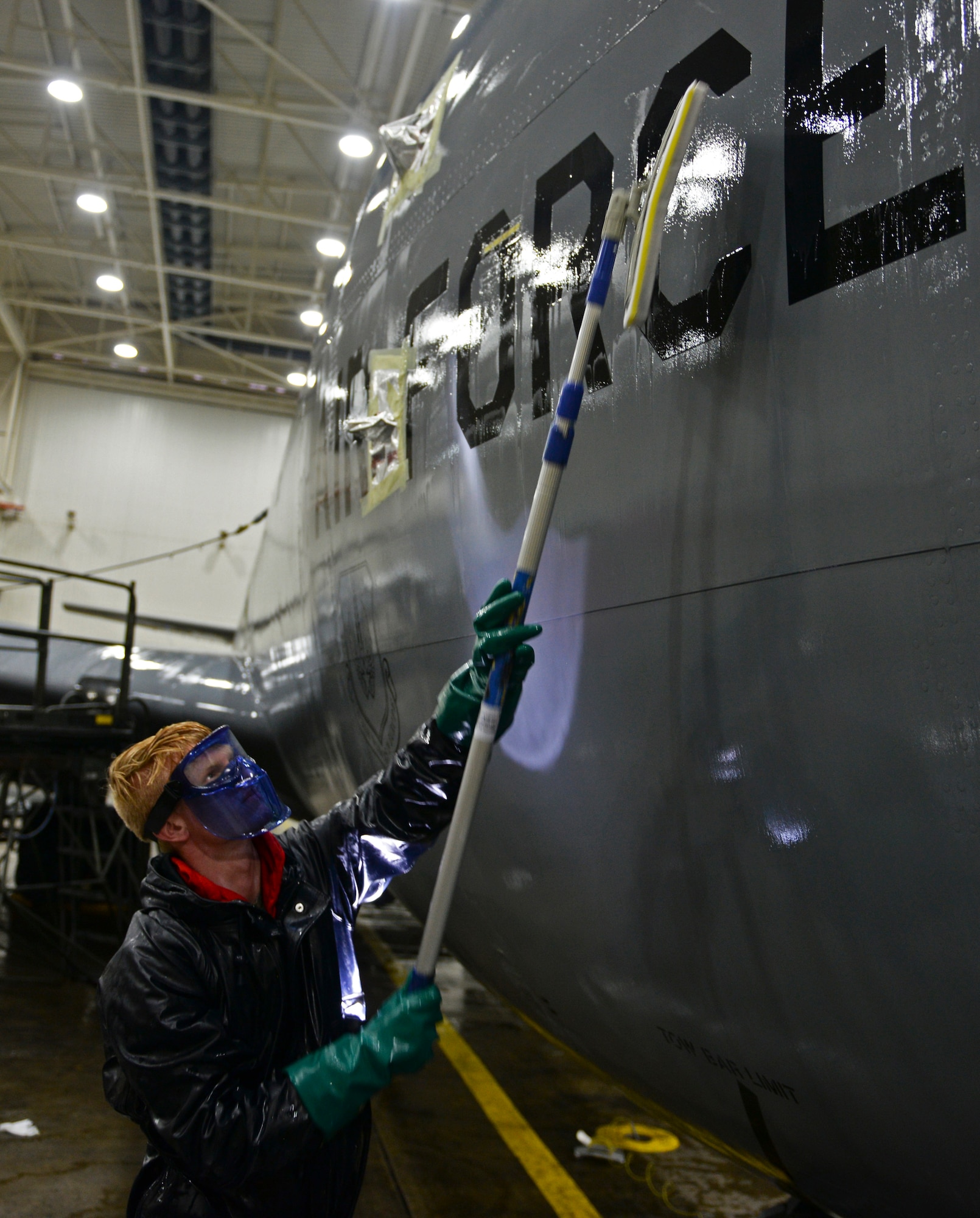 U.S. Air Force Airman Paul Hendra, 100th Maintenance Squadron aircraft structural maintenance apprentice, scrubs the side of a KC-135 Stratotanker Nov. 23, 2015, on RAF Mildenhall, England. After 60 days, aircraft must be cleaned of dirt, grime and dust as a part of corrosion control. (U.S. Air Force photo by Staff Sgt. Micaiah Anthony/Released)